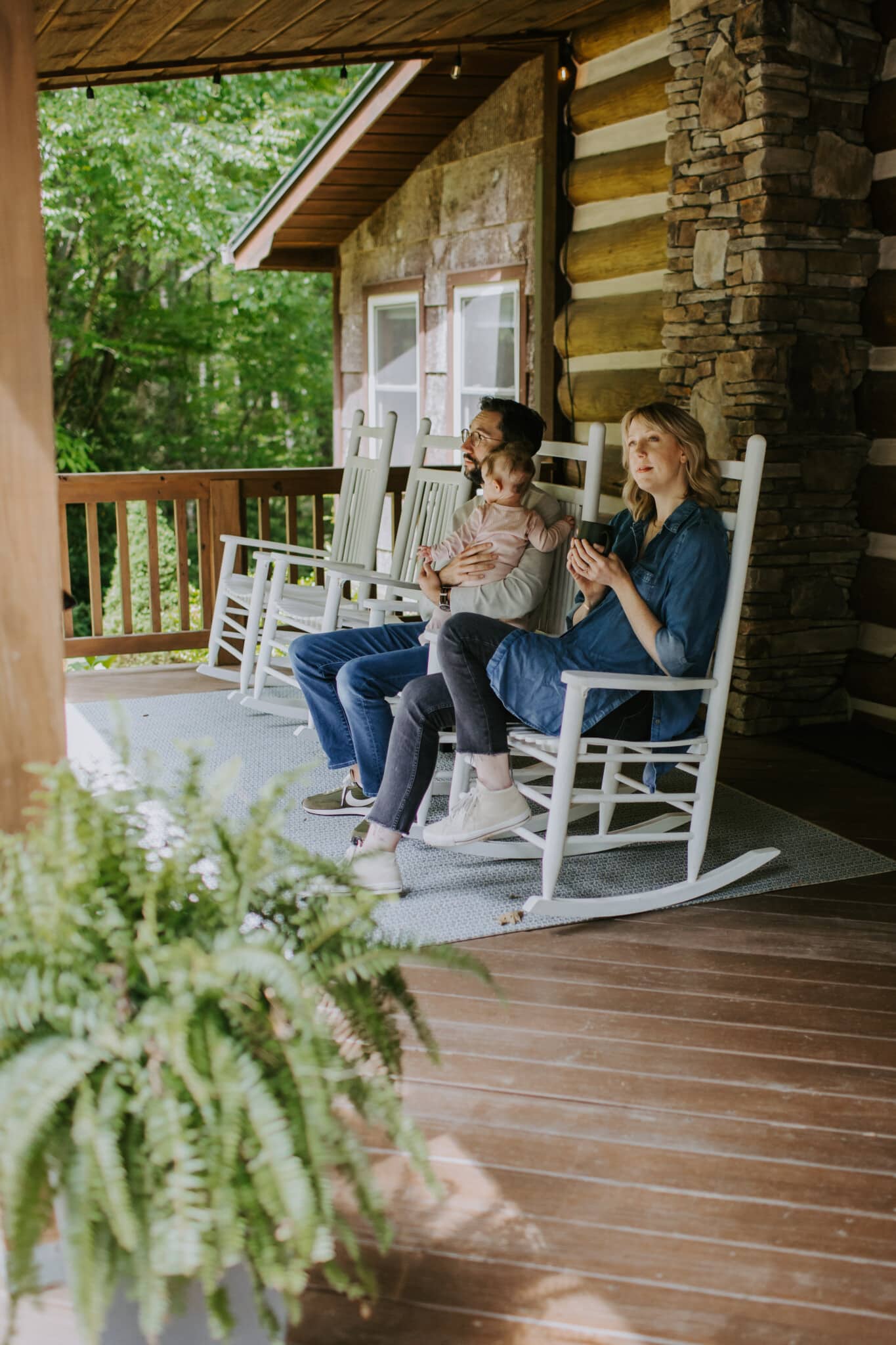 family sitting on the front porch hemlock hill cabin blowing rock, north carolina
