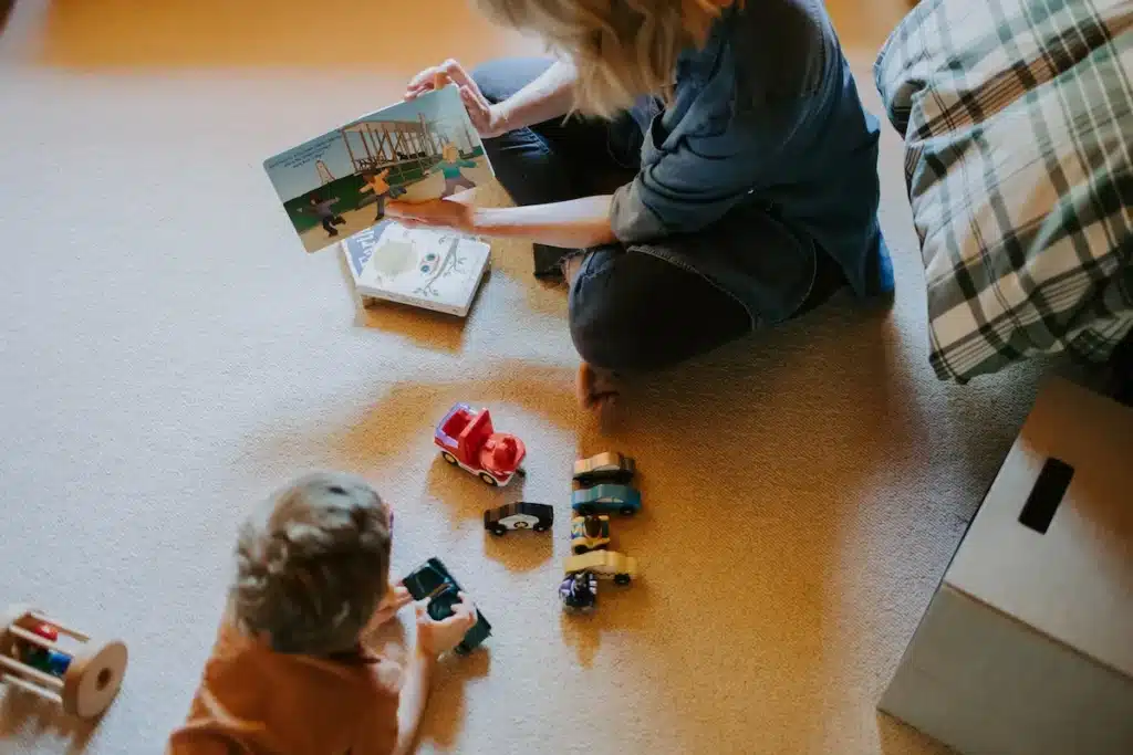 Mom reading a book from a selection of books and toys offered at Hemlock Hill Cabin